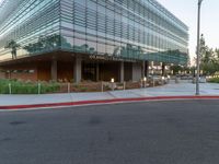 two grey blocks sitting next to a tall building on a sidewalk in front of grass