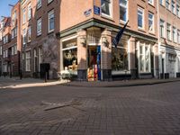 a brick road leads to a large store with a sign on the corner reading'go to bed '