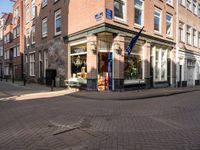 a brick road leads to a large store with a sign on the corner reading'go to bed '