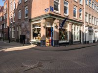 a brick road leads to a large store with a sign on the corner reading'go to bed '