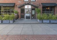 this is the exterior of a restaurant, showing off the front entrance of it and two windowed front doors