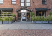 this is the exterior of a restaurant, showing off the front entrance of it and two windowed front doors