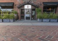 this is the exterior of a restaurant, showing off the front entrance of it and two windowed front doors