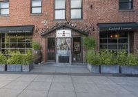 this is the exterior of a restaurant, showing off the front entrance of it and two windowed front doors