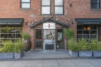 this is the exterior of a restaurant, showing off the front entrance of it and two windowed front doors