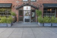 this is the exterior of a restaurant, showing off the front entrance of it and two windowed front doors