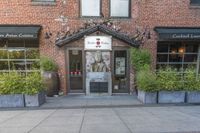 this is the exterior of a restaurant, showing off the front entrance of it and two windowed front doors