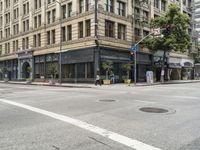 a person is walking across the street in the daytime time and crosswalk has a white line going down it