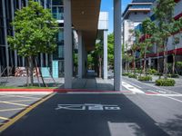 a red crosswalk sits next to tall buildings in an urban area, near a pedestrian crossing