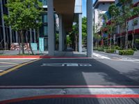 a red crosswalk sits next to tall buildings in an urban area, near a pedestrian crossing