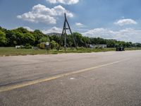 an empty runway and construction equipment on the side of the road in a suburban area