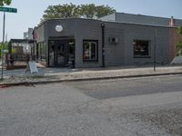 a store on the corner in a small town that has lots of gray brick walls