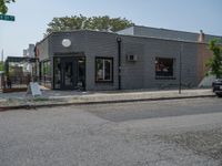 a store on the corner in a small town that has lots of gray brick walls