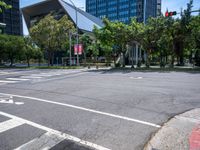 street intersection with a traffic light, trees and an airport building in the background on a sunny day