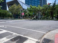 street intersection with a traffic light, trees and an airport building in the background on a sunny day