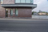 the sign is at the entrance to storage door in front of an empty building on the corner