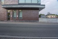 the sign is at the entrance to storage door in front of an empty building on the corner