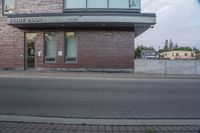 the sign is at the entrance to storage door in front of an empty building on the corner