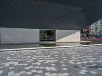 a white building next to a pool in a courtyard area with a walkway leading into it