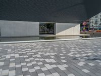 a white building next to a pool in a courtyard area with a walkway leading into it