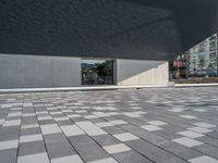 a white building next to a pool in a courtyard area with a walkway leading into it