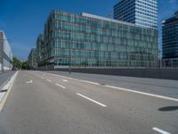 street view in urban area with buildings and traffic lights on clear day with blue sky