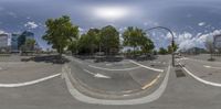 a 360 view of an intersection in a park with a large clock tower in the middle