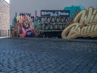 a truck in front of a large sign for the brewery wild budaic on the side of a wall