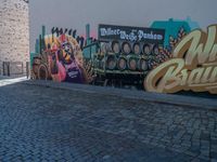 a truck in front of a large sign for the brewery wild budaic on the side of a wall