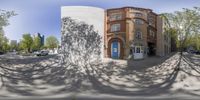 an image of a building on the street in the shadow of trees on the ground