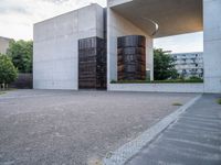 two empty parking spaces with metal tanks on them and one building with a gate open