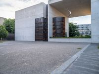 two empty parking spaces with metal tanks on them and one building with a gate open