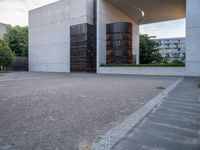 two empty parking spaces with metal tanks on them and one building with a gate open