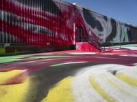 a building with colorful painting on it outside of a shopping center in the day light