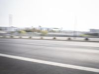 a motorcyclist driving on a highway in the city area of an urban setting