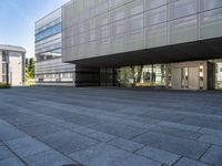 an empty courtyard of some kind of public building near a building's entryway