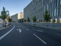 a building and roadway in front of an office building on the other side of a street