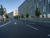 a building and roadway in front of an office building on the other side of a street