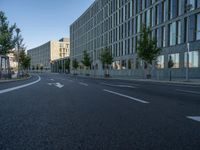 a building and roadway in front of an office building on the other side of a street