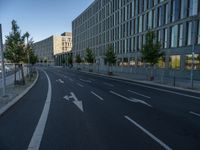 a building and roadway in front of an office building on the other side of a street