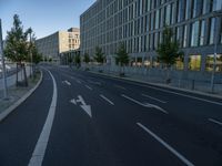 a building and roadway in front of an office building on the other side of a street