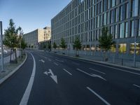 a building and roadway in front of an office building on the other side of a street