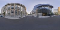 two circular panoramic mirrors in different locations, both showing the street and buildings