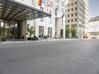 this is an empty street with traffic in the background, and two tall buildings on either side