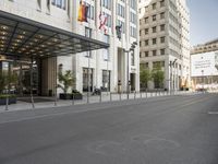 this is an empty street with traffic in the background, and two tall buildings on either side