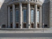 an entrance of a building with large columns and doors that spell out the word voltege