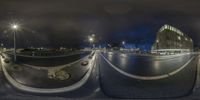 there is a fish - eye lens view of a city street at night time of the camera