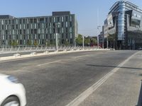 an intersection with buildings and cars parked on either side of it, in the distance