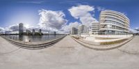 a view of the city through the fish eye lens, in this image there are a few boats nearby