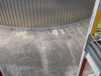 a photo looking down onto a cement floor with stairs leading to the bottom of the wall